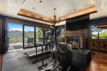 Experience luxury fitness with this state-of-the-art home gym, featuring a treadmill and elliptical with breathtaking mountain views.