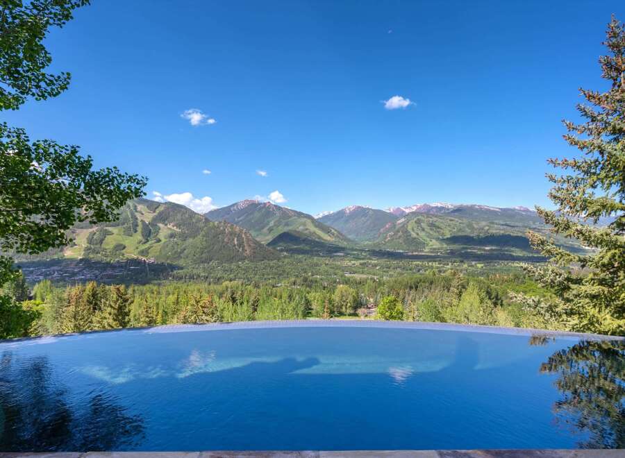 Experience unparalleled luxury with this stunning infinity pool offering breathtaking panoramic views of the surrounding mountains and valley.