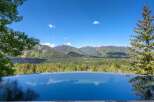 Experience unparalleled luxury with this stunning infinity pool offering breathtaking panoramic views of the surrounding mountains and valley.