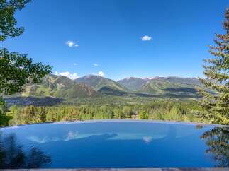 Experience unparalleled luxury with this stunning infinity pool offering breathtaking panoramic views of the surrounding mountains and valley.