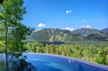 Experience luxury living with this stunning infinity pool offering breathtaking panoramic views of the surrounding mountains and lush greenery.