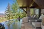 Experience luxury outdoor living with this stunning infinity pool overlooking a picturesque mountain landscape.