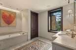 Indulge in luxury with this stunning bathroom featuring a deep soaking tub and a spacious double vanity.