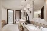 Indulge in luxury with this exquisite bathroom featuring dual vanities, a spacious walk-in shower, and a separate water closet.