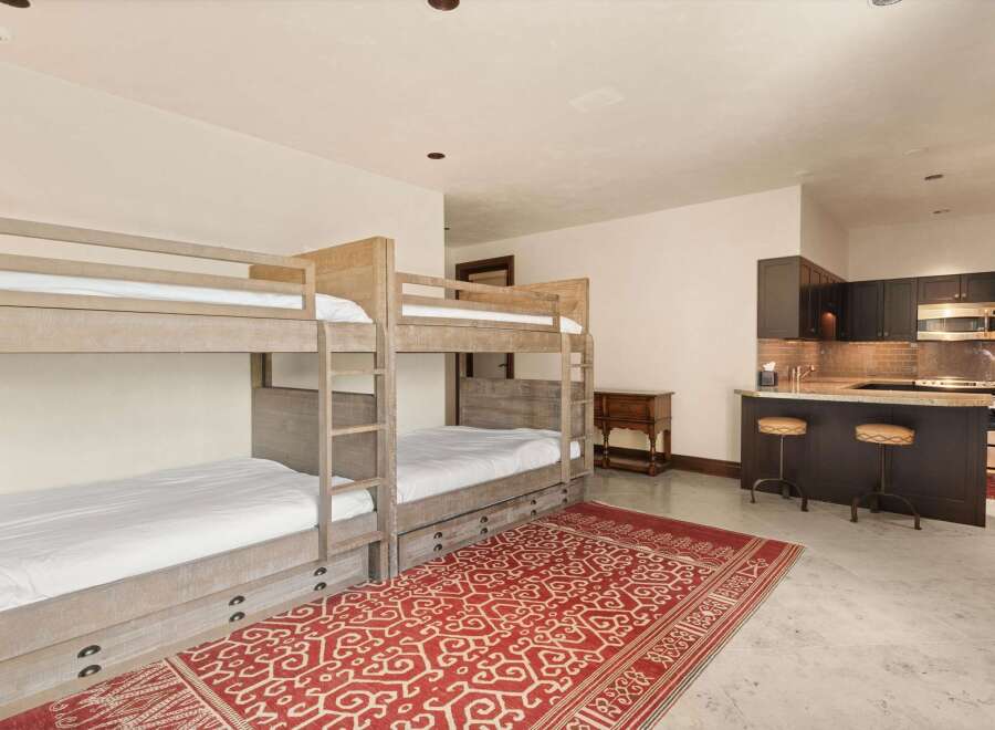 This spacious room features a set of rustic wooden bunk beds, perfect for accommodating guests or family.
