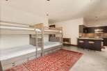 This spacious room features a set of rustic wooden bunk beds, perfect for accommodating guests or family.