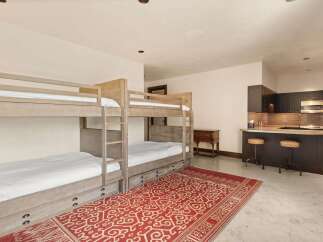 This spacious room features a set of rustic wooden bunk beds, perfect for accommodating guests or family.