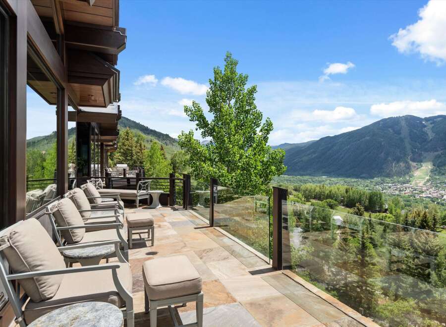 Experience breathtaking mountain views from this stunning contemporary home's expansive patio.