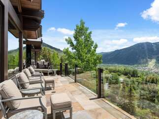 Experience breathtaking mountain views from this stunning contemporary home's expansive patio.