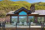 Experience breathtaking mountain views from this stunning modern home, featuring expansive windows and a spacious deck perfect for enjoying the scenery.