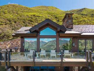 Experience breathtaking mountain views from this stunning modern home, featuring expansive windows and a spacious deck perfect for enjoying the scenery.