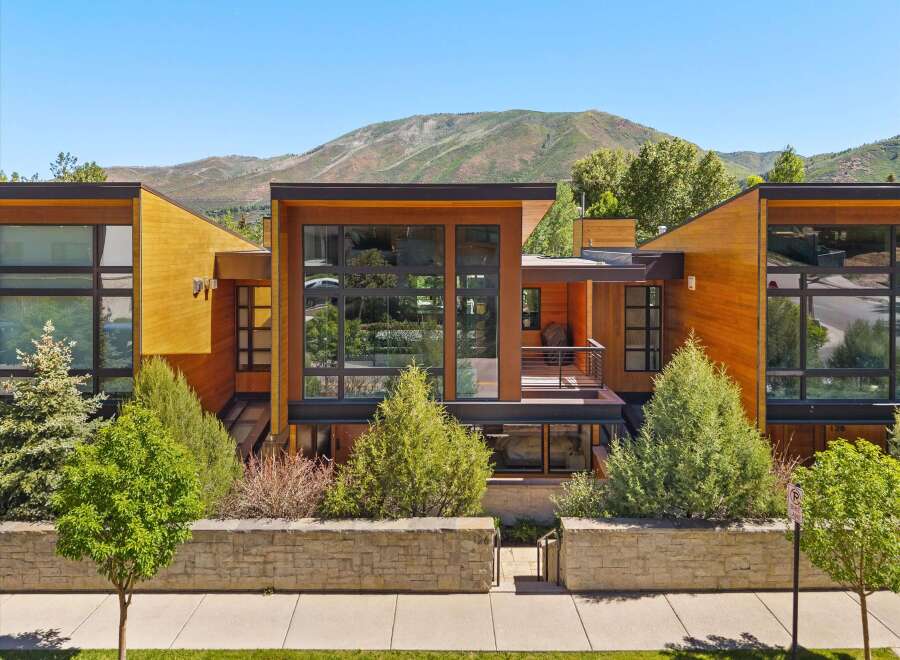Experience modern luxury in this stunning architectural home, featuring expansive glass windows and warm wood accents that seamlessly blend indoor and outdoor living.