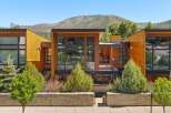 Experience modern luxury in this stunning architectural home, featuring expansive glass windows and warm wood accents that seamlessly blend indoor and outdoor living.