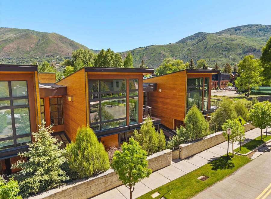 Experience modern luxury in this stunning architectural home, featuring warm wood exteriors and expansive glass windows that invite natural light.