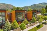 Experience modern luxury in this stunning architectural home, featuring warm wood exteriors and expansive glass windows that invite natural light.