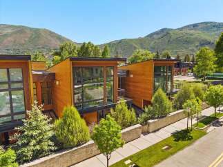 Experience modern luxury in this stunning architectural home, featuring warm wood exteriors and expansive glass windows that invite natural light.