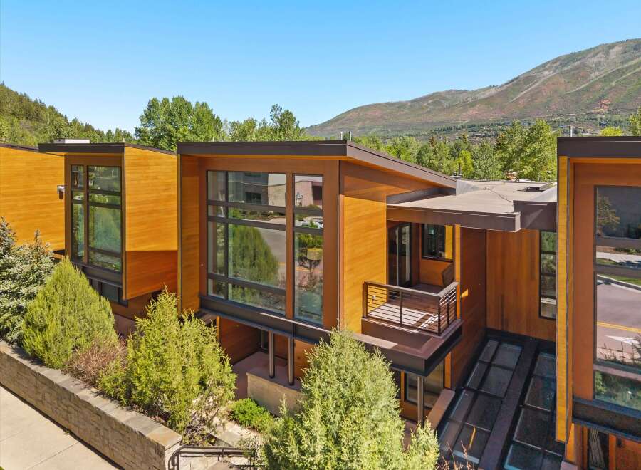 Experience modern luxury in this stunning architectural home, featuring warm wood exteriors and expansive glass windows that invite natural light.
