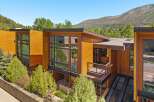 Experience modern luxury in this stunning architectural home, featuring warm wood exteriors and expansive glass windows that invite natural light.