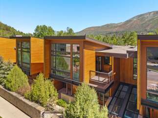 Experience modern luxury in this stunning architectural home, featuring warm wood exteriors and expansive glass windows that invite natural light.