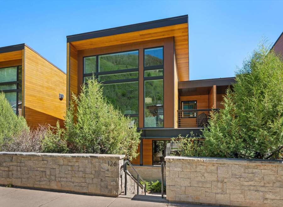 Experience modern luxury in this stunning architectural home, featuring expansive windows that capture breathtaking mountain views.
