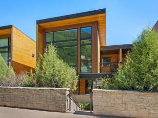 Experience modern luxury in this stunning architectural home, featuring expansive windows that capture breathtaking mountain views.