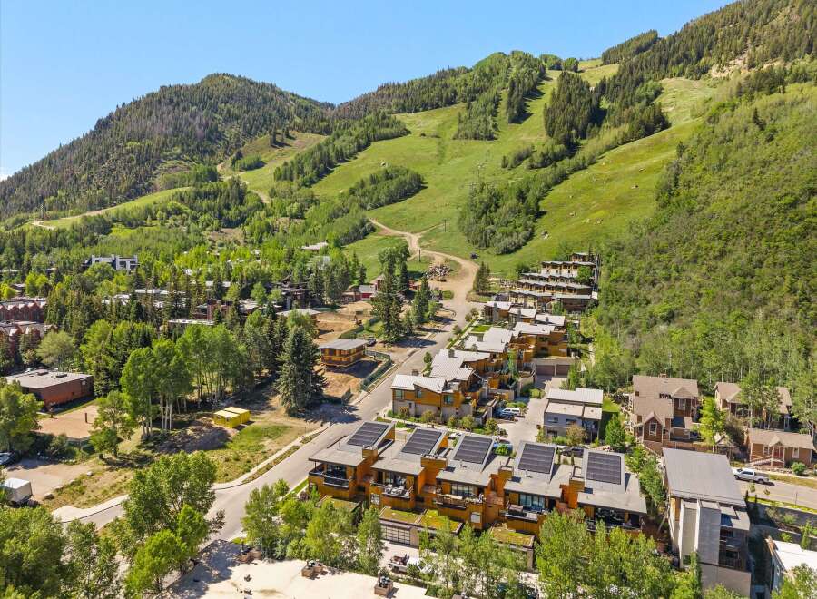 Experience luxury mountain living in this stunning property, featuring modern architecture with solar panels and green roofs.