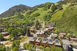 Experience luxury mountain living in this stunning property, featuring modern architecture with solar panels and green roofs.