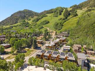 Experience luxury mountain living in this stunning property, featuring modern architecture with solar panels and green roofs.
