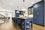 Experience luxury in this stunning modern kitchen, featuring deep navy custom cabinetry and a spacious island perfect for entertaining.