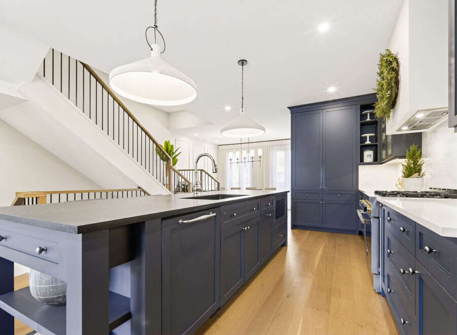 Experience luxury in this stunning modern kitchen, featuring a spacious island with a built-in sink and ample cabinetry.