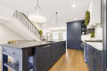 Experience luxury in this stunning modern kitchen, featuring a spacious island with a built-in sink and ample cabinetry.