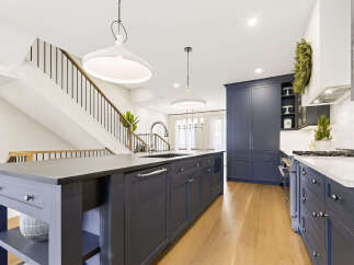 Experience luxury in this stunning modern kitchen, featuring a spacious island with a built-in sink and ample cabinetry.