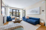 Experience modern living in this stunning living room, featuring plush blue velvet sofas that invite relaxation.
