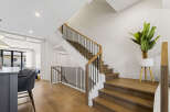 Experience modern living with this stunning staircase featuring rich hardwood treads and a sleek black metal railing.