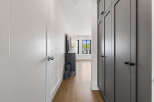 Step into a beautifully designed hallway featuring a sleek, modern aesthetic.