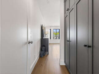 Step into a beautifully designed hallway featuring a sleek, modern aesthetic.