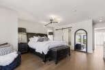 Experience luxury in this master suite, featuring a king-size bed with plush bedding and elegant bedside tables.
