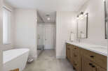 Experience luxury in this stunning bathroom featuring a freestanding soaking tub and a spacious glass-enclosed shower.