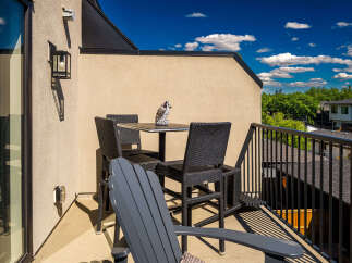 Enjoy your morning coffee or evening drinks on this charming balcony, perfect for outdoor relaxation.