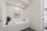 Indulge in relaxation in this luxurious bathroom featuring a spacious built-in bathtub surrounded by elegant white tilework.