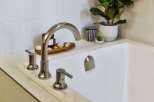 Experience luxury in this bathroom featuring a sleek, modern bathtub with a polished chrome faucet.