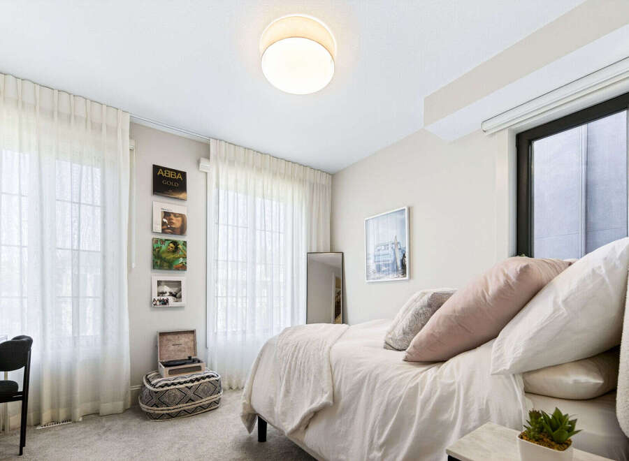 This charming bedroom features a cozy queen-size bed adorned with plush pillows and a soft duvet, perfect for relaxation.