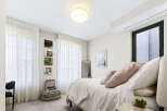 This charming bedroom features a cozy queen-size bed adorned with plush pillows and a soft duvet, perfect for relaxation.