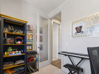 Discover a unique space featuring a striking bookshelf filled with decorative items and personal memorabilia.