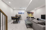 Discover this modern basement living space, perfect for relaxation and entertainment.