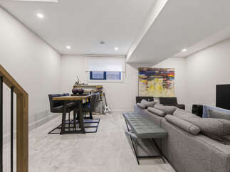 Discover this modern basement living space, perfect for relaxation and entertainment.
