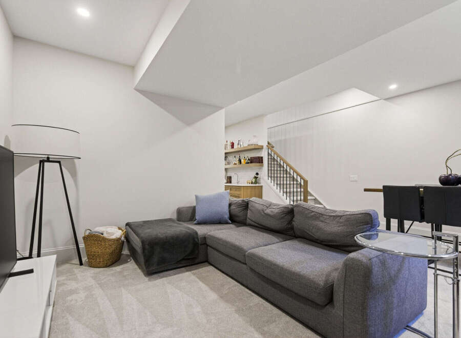 This modern living space features a spacious sectional sofa perfect for relaxation and entertaining.