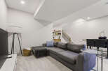 This modern living space features a spacious sectional sofa perfect for relaxation and entertaining.