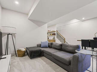 This modern living space features a spacious sectional sofa perfect for relaxation and entertaining.