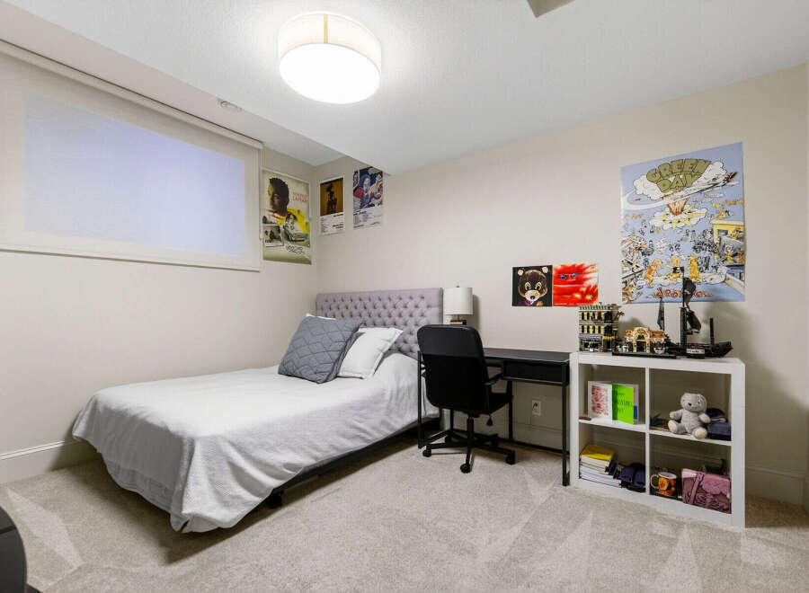 This bedroom features a comfortable twin bed with a tufted headboard, perfect for a guest room or child's space.